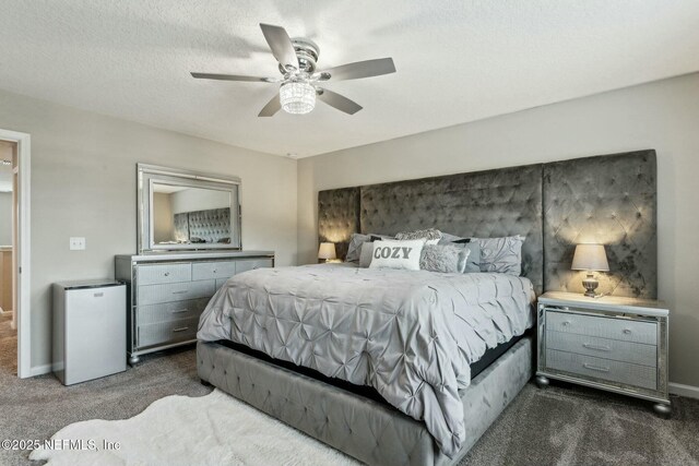 carpeted bedroom featuring a textured ceiling, a ceiling fan, and baseboards