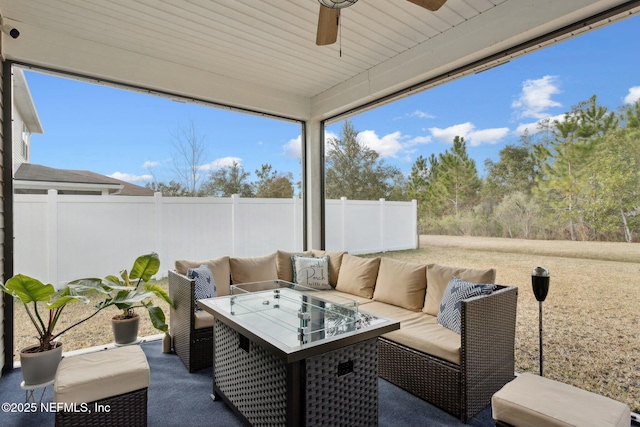 sunroom / solarium featuring a ceiling fan