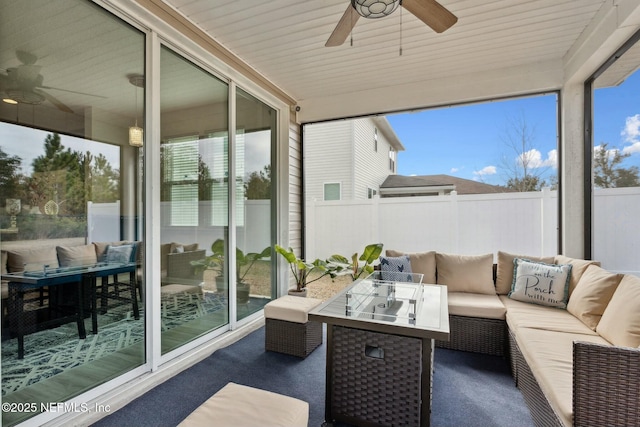 sunroom / solarium with a ceiling fan and a healthy amount of sunlight