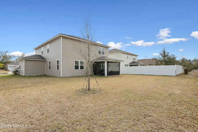 rear view of house with a gazebo, fence, and a yard