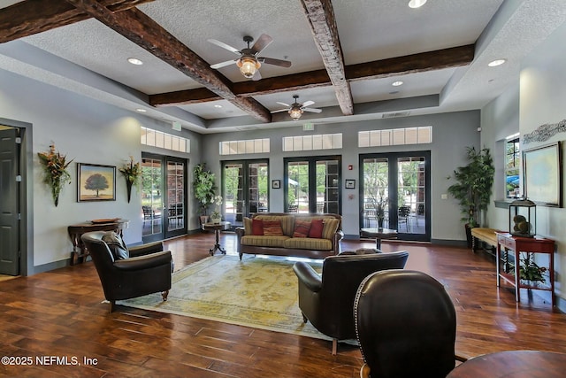 living room featuring french doors, coffered ceiling, baseboards, and hardwood / wood-style flooring