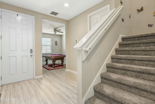 staircase featuring pool table, visible vents, ceiling fan, wood finished floors, and baseboards