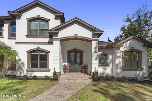 view of front facade featuring a front lawn and french doors