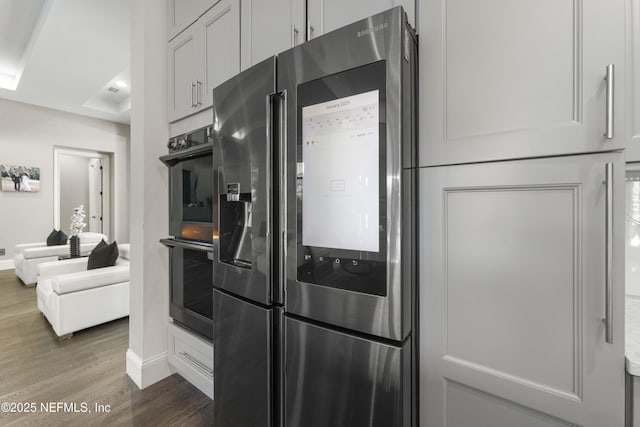 kitchen featuring stainless steel appliances, dark hardwood / wood-style floors, and white cabinets