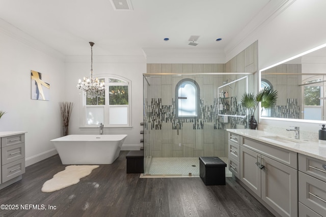 bathroom with crown molding, shower with separate bathtub, hardwood / wood-style floors, and vanity