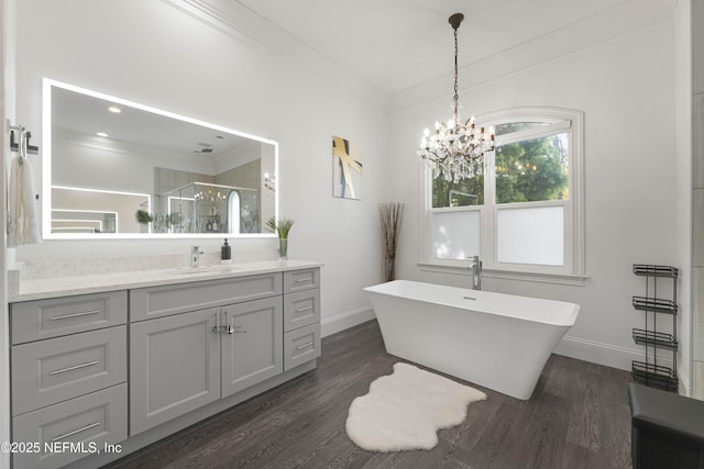 bathroom featuring an inviting chandelier, ornamental molding, separate shower and tub, and wood-type flooring