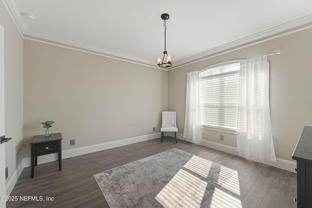 sitting room with crown molding, dark hardwood / wood-style floors, and a chandelier