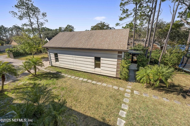 view of property exterior featuring a yard and a trampoline