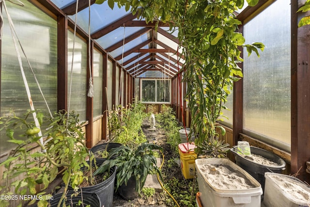 sunroom / solarium featuring vaulted ceiling with beams and a wealth of natural light