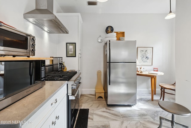 kitchen with island range hood, stainless steel appliances, hanging light fixtures, and white cabinets