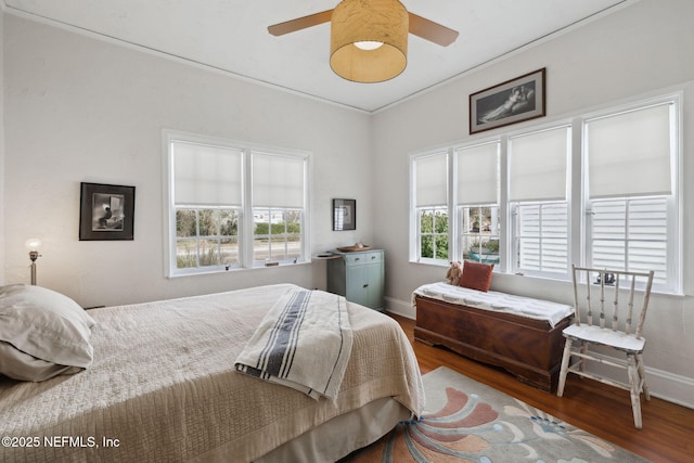 bedroom with hardwood / wood-style flooring, ornamental molding, lofted ceiling, and ceiling fan