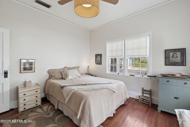 bedroom featuring dark wood-type flooring, ceiling fan, and crown molding