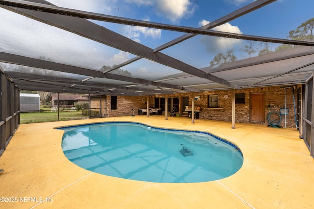 view of pool featuring a patio and glass enclosure