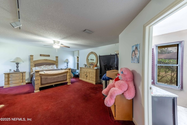 carpeted bedroom with a textured ceiling and ceiling fan