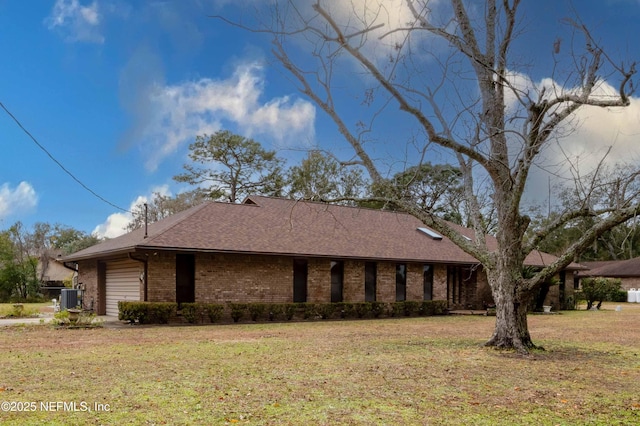 view of side of property with a yard and central AC unit