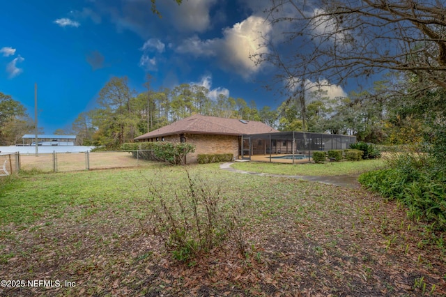 view of yard with a fenced in pool and a lanai