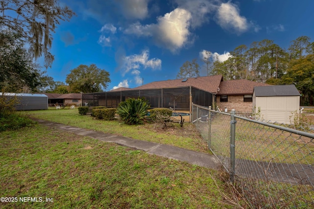 view of yard with a storage shed, a lanai, and a fenced in pool