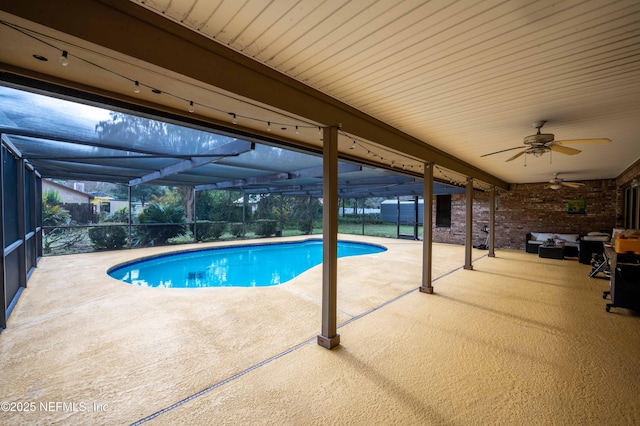 view of pool featuring ceiling fan, an outdoor living space, a lanai, and a patio area