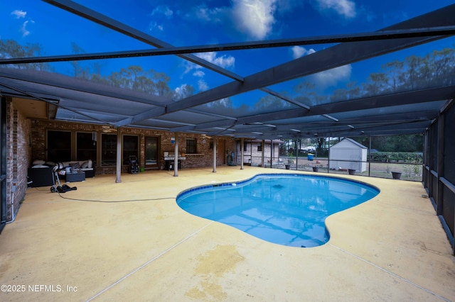 view of pool with a patio and glass enclosure