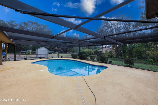 view of pool featuring a patio and glass enclosure