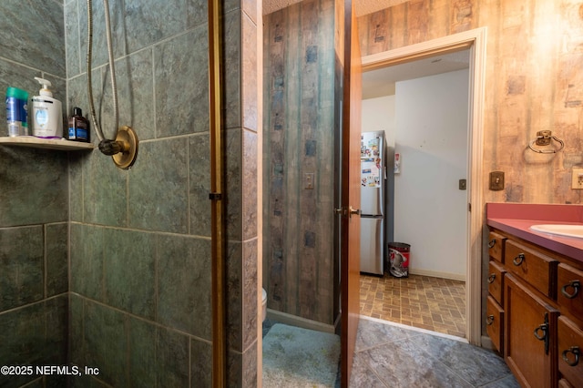 bathroom featuring vanity, toilet, and a shower