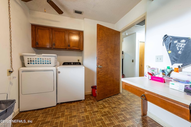 washroom with cabinets, ceiling fan, a textured ceiling, and independent washer and dryer