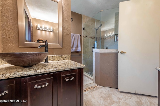 bathroom with walk in shower, tile patterned floors, and vanity