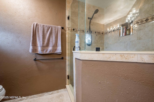 bathroom with tiled shower and toilet