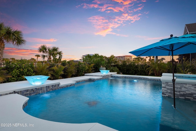 view of pool at dusk