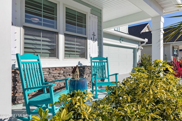 view of patio with a garage and covered porch