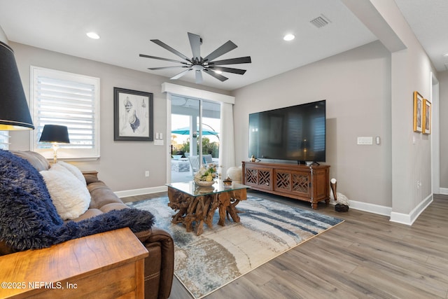 living room with hardwood / wood-style floors and ceiling fan