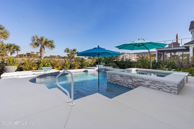 view of pool with an in ground hot tub, pool water feature, and a patio