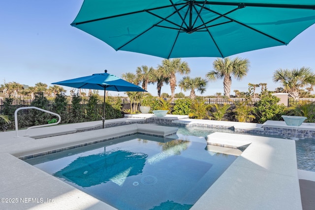 view of pool with an in ground hot tub