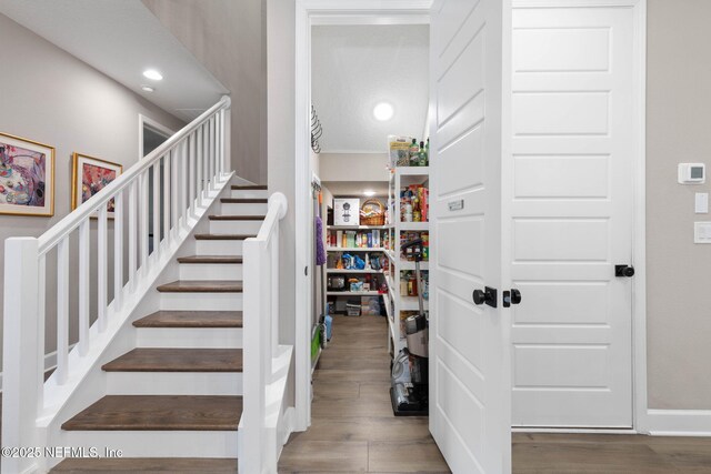 stairway with hardwood / wood-style floors