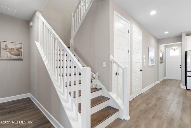 stairs featuring hardwood / wood-style flooring