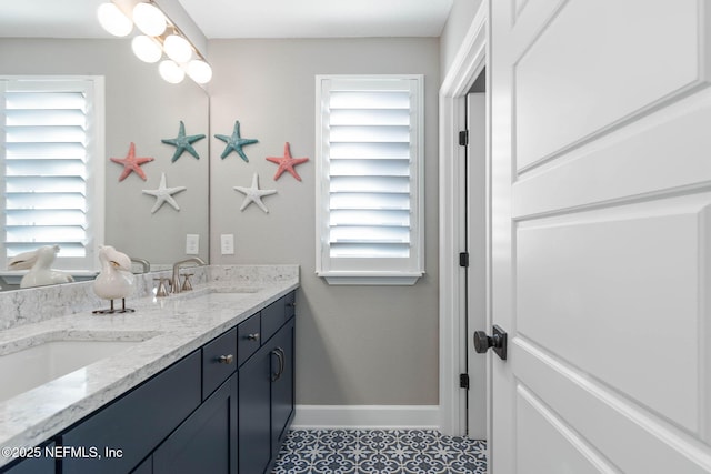 bathroom with vanity, a wealth of natural light, and tile patterned floors