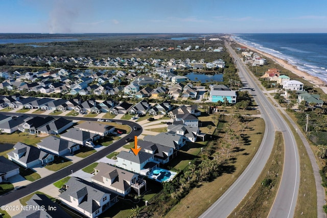 aerial view featuring a water view and a view of the beach