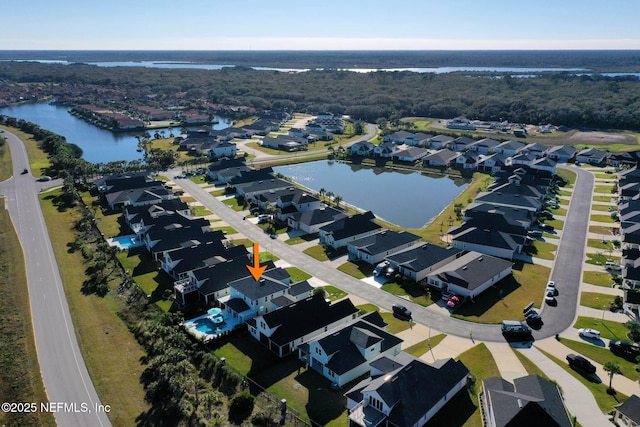 birds eye view of property with a water view