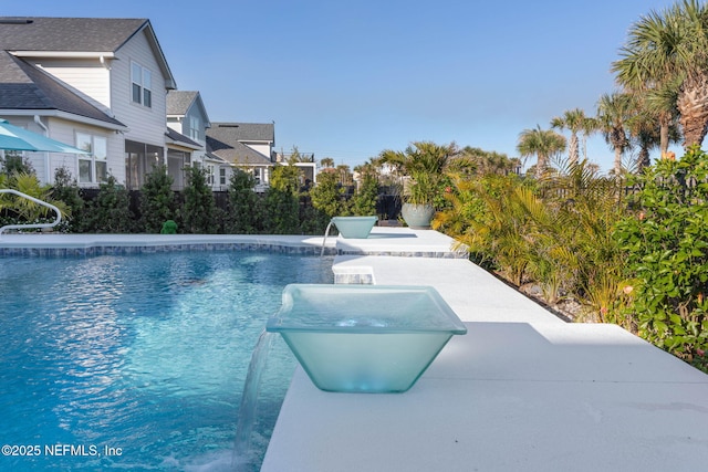 view of swimming pool featuring pool water feature and a patio area