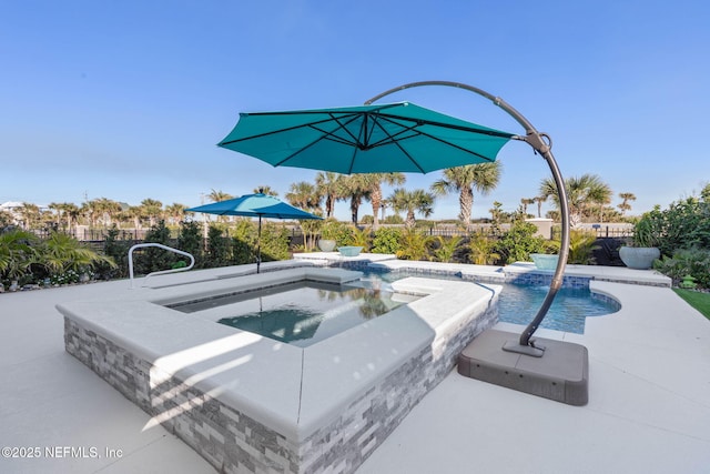 view of swimming pool with an in ground hot tub