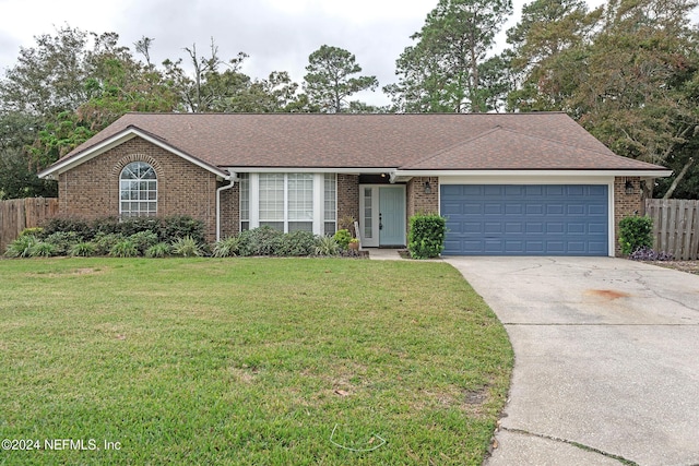 ranch-style house featuring a garage and a front yard