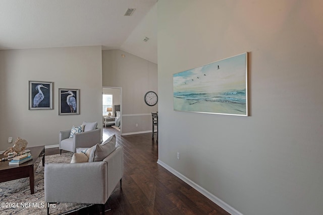 living room featuring vaulted ceiling and dark wood-type flooring