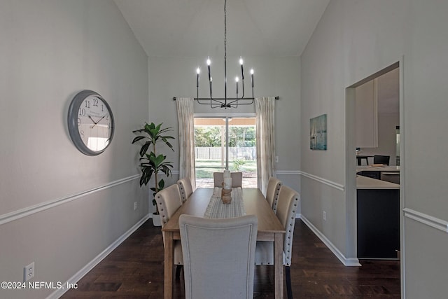 dining room with a towering ceiling, dark hardwood / wood-style flooring, and a notable chandelier