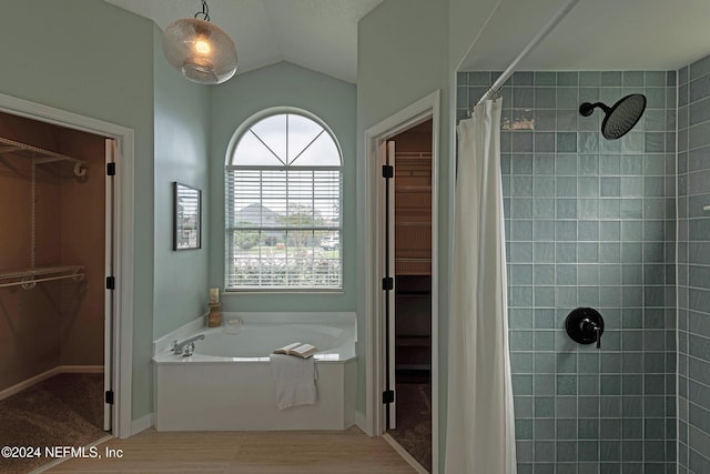 bathroom featuring vaulted ceiling and shower with separate bathtub