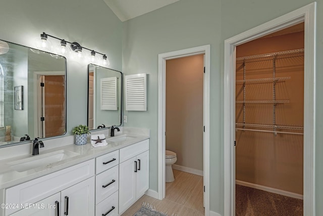 bathroom featuring vanity, tile patterned floors, and toilet