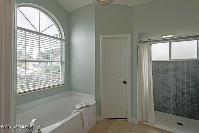 bathroom with independent shower and bath, a healthy amount of sunlight, and tile patterned flooring