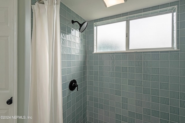 bathroom featuring a shower with curtain