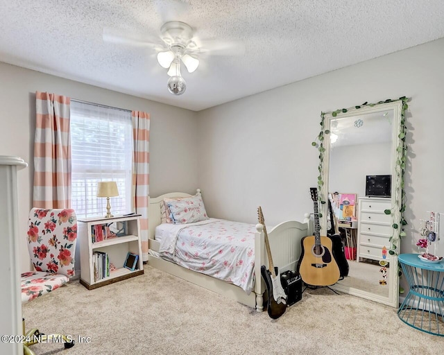 bedroom with a textured ceiling, ceiling fan, and carpet flooring