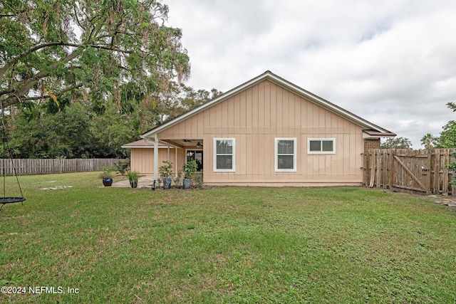 back of property featuring a lawn