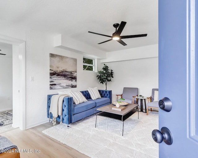 living room featuring hardwood / wood-style flooring and ceiling fan